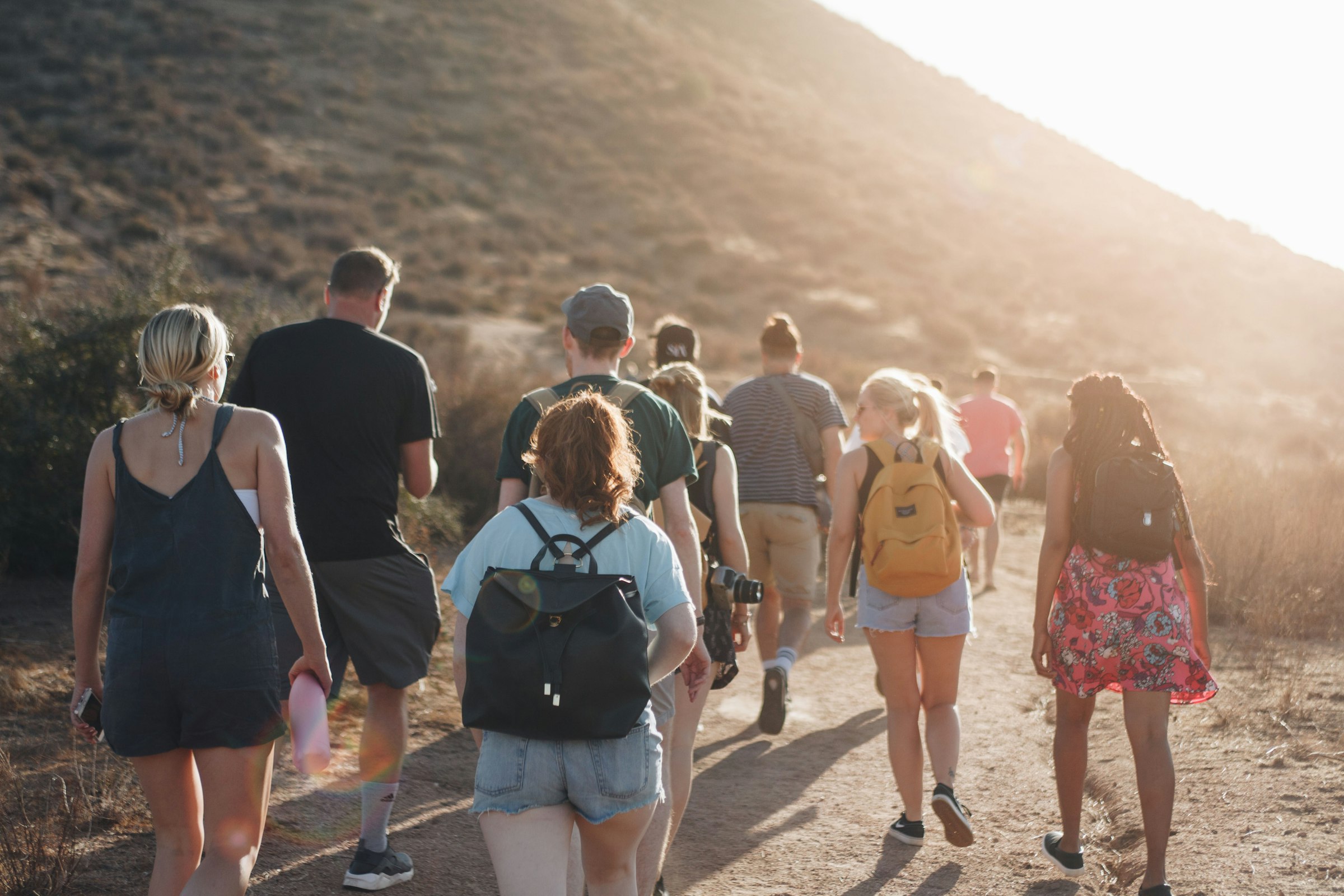 Group of friends hiking a dirt trail together